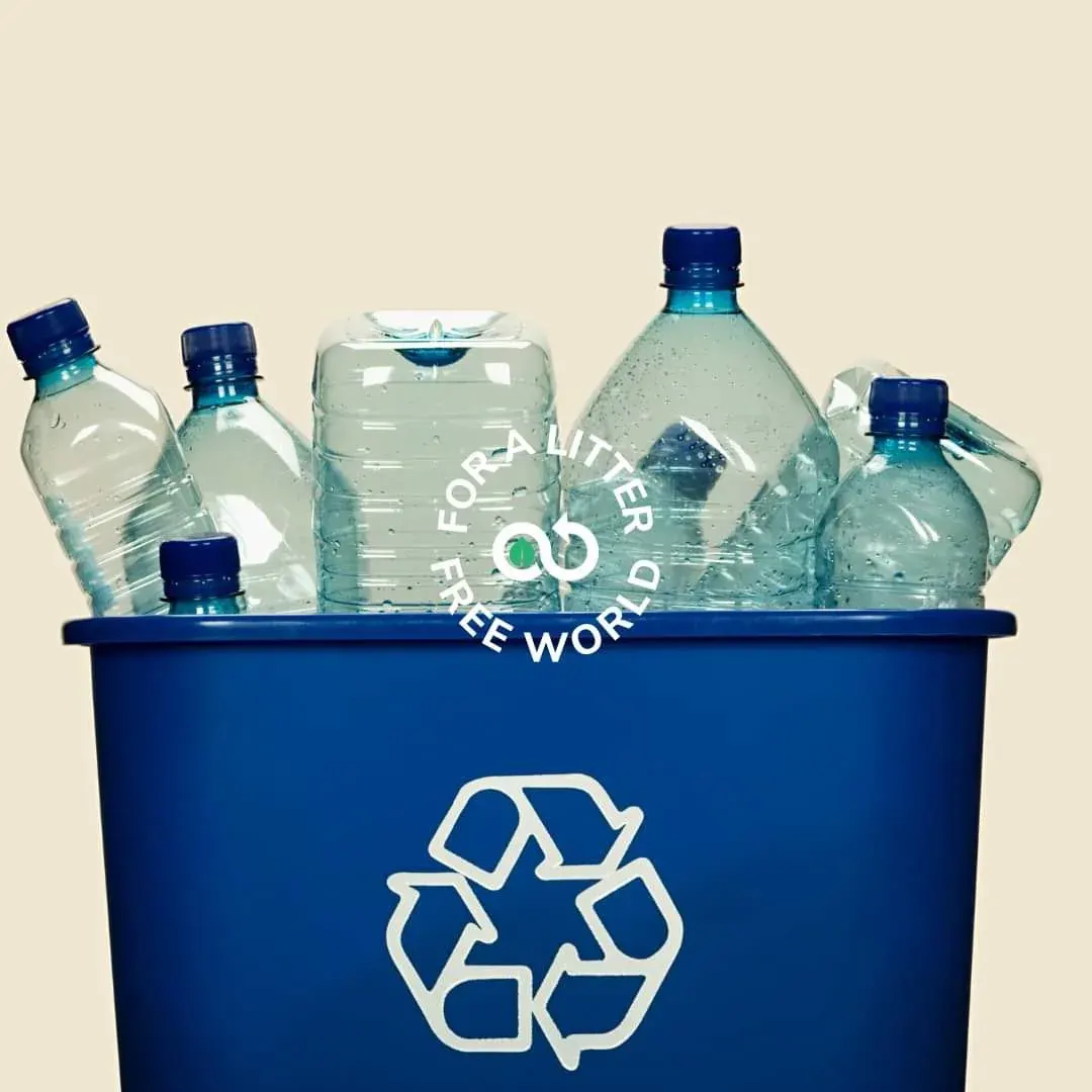 Plastic bottles in a blue recycling bin with a litter-free world message Plastic bottles in a blue recycling bin with a litter-free world message