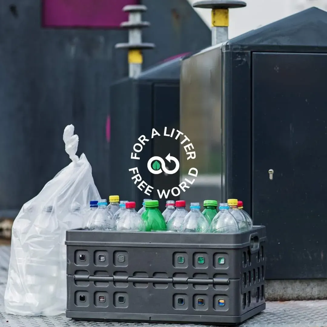 Cardboard crate of empty plastic bottles and a litter-free world logo highlighting plastic waste in the UAE Cardboard crate of empty plastic bottles and a litter-free world logo highlighting plastic waste in the UAE